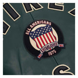 Close-up of a dark green embroidered sports jersey patch featuring an American flag design with the text 'ALL AMERICANS', 'ESTABLISHED N.Y.
