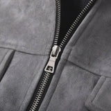 Close-up of a gray suede or micro-suede zip jacket with a silver metal zipper and pull tab.