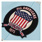 Embroidered patch with American flag design and text on a light blue background