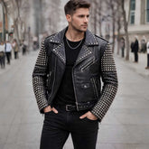 Man wearing black studded leather jacket styled with jeans and boots