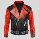 A black and red motorcycle-style leather jacket with heavy silver studded detailing, a front zipper, and graphic patches on the chest, shown on a plain light gray background.