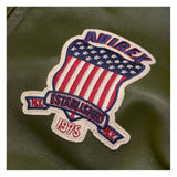 Patch with American flag design and 'Oxbow' branding on a green leather surface