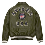 An olive green leather jacket shown from the back, featuring 'AVIREX USA' embroidered in white varsity lettering with a central circular American flag patch.