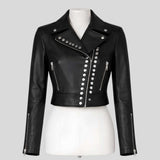 Close-up of silver studs on women's cropped leather jacket