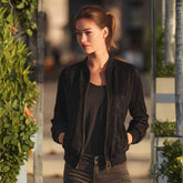 Woman wearing black suede bomber jacket with jeans