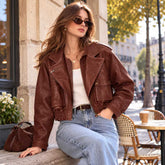 Woman wearing brown oversized leather jacket with jeans