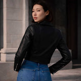 Back view of women's cropped leather biker jacket