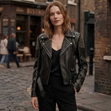 Women's black studded leather biker jacket with silver rivets, front view