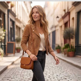 Side profile of women's tan suede moto jacket