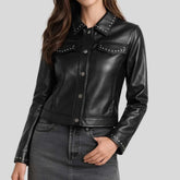 Women's black studded leather shirt jacket front view — golden stud collar and snap button closure