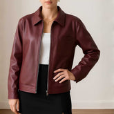 Maroon leather jacket worn by a person on a neutral background