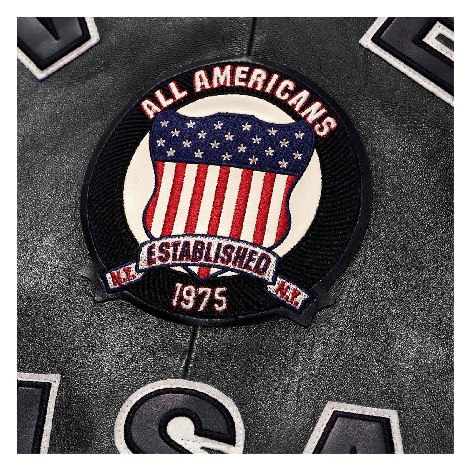 A circular embroidered patch featuring an American flag design with the text 'ALL AMERICANS' and 'ESTABLISHED 1975' on a black leather background.