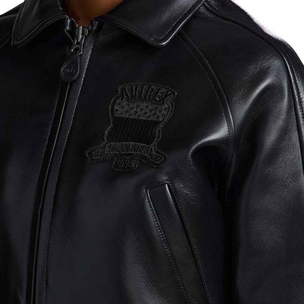 Black leather jacket with a logo on the chest