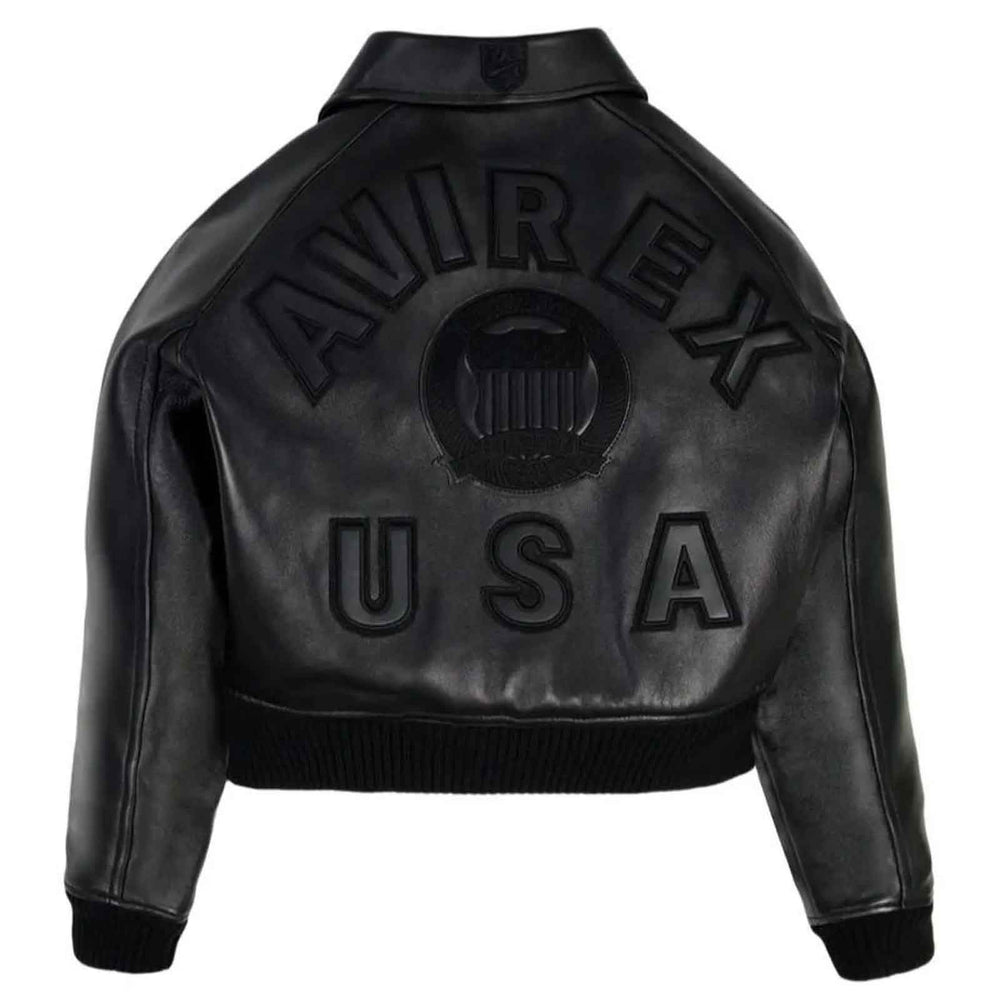 Black leather bomber jacket shown from the back, featuring embossed 'AVIREX' lettering and a central crest emblem, with 'USA' embossed below, on a plain white background.