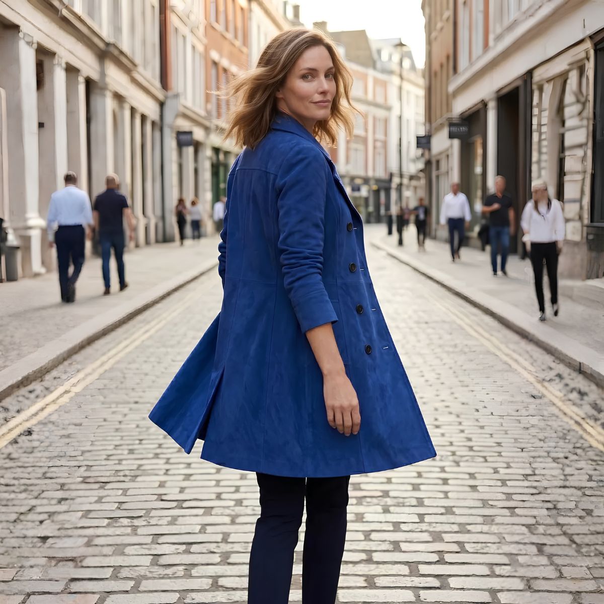 Back view of women's long blue suede coat