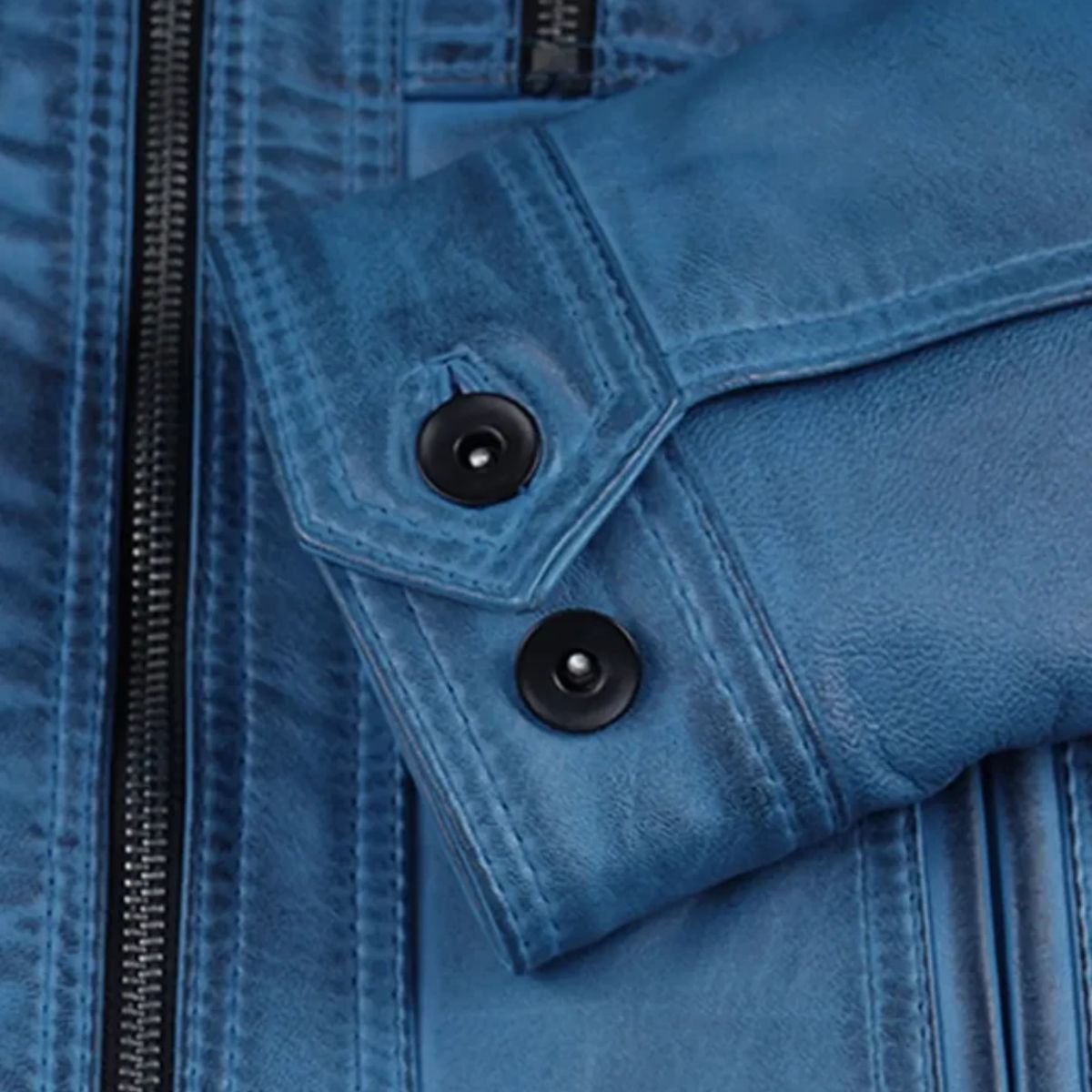 Close-up detail of a blue leather jacket showing a flap pocket with two black snap buttons and a black zipper.