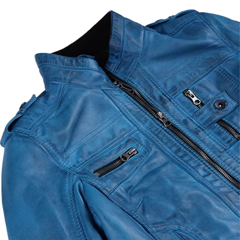 Close-up of a blue leather jacket with black zippers, a black collar lining, and silver-toned hardware on a white background.