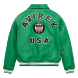 A green leather varsity jacket shown from the back, featuring 'AVIREX USA' in large black letters with white outlines, a circular American flag patch in the center, and white and black striped ribbed cuffs and hem.
