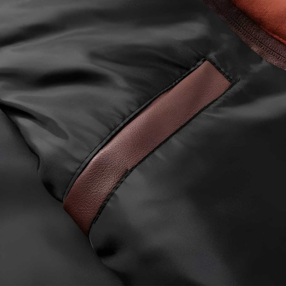 Close-up detail of a black jacket with a brown leather-like trim accent.