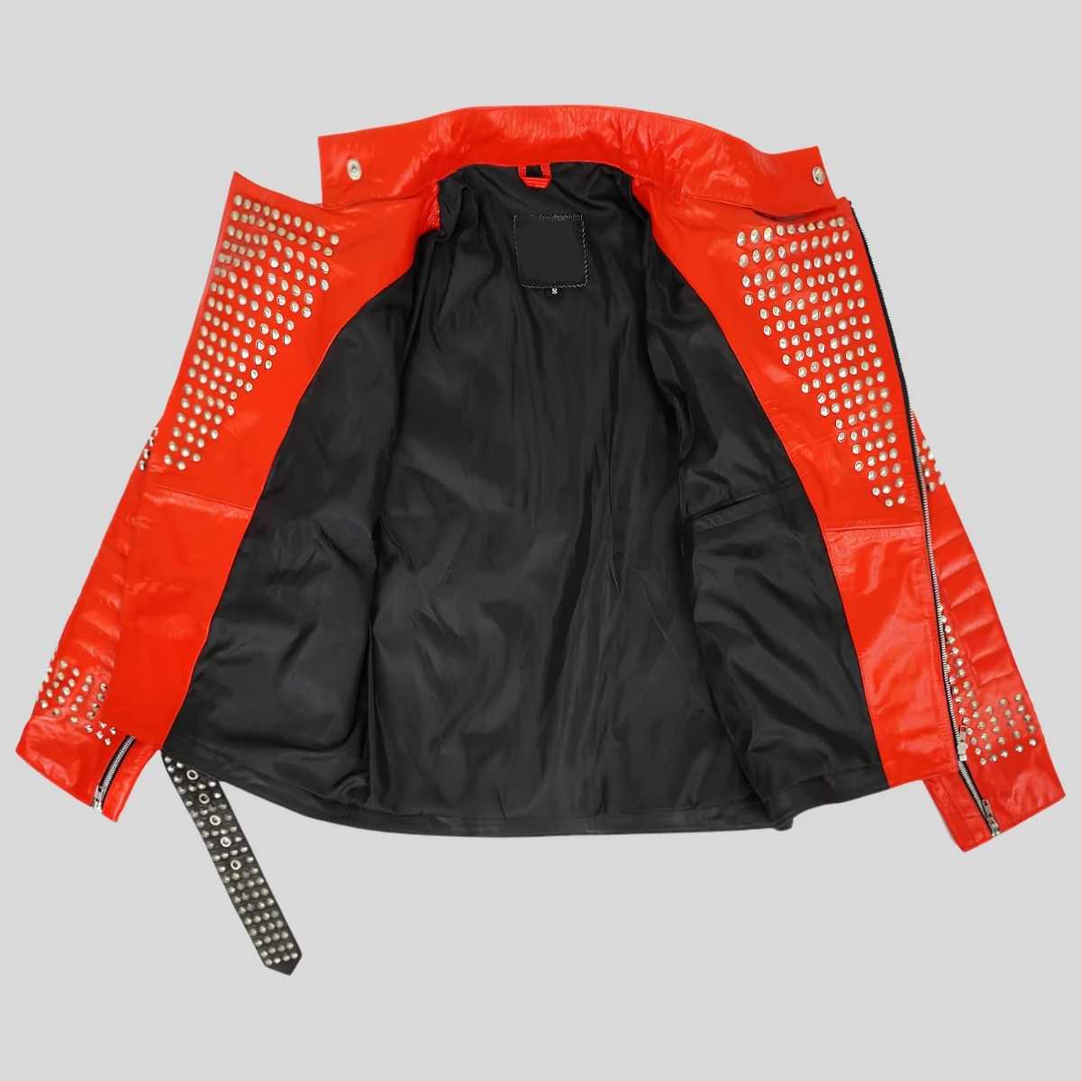 A red and black studded jacket laid flat on a light gray background. The outer panels are a vibrant red with rows of silver studs, while the inner lining is black.