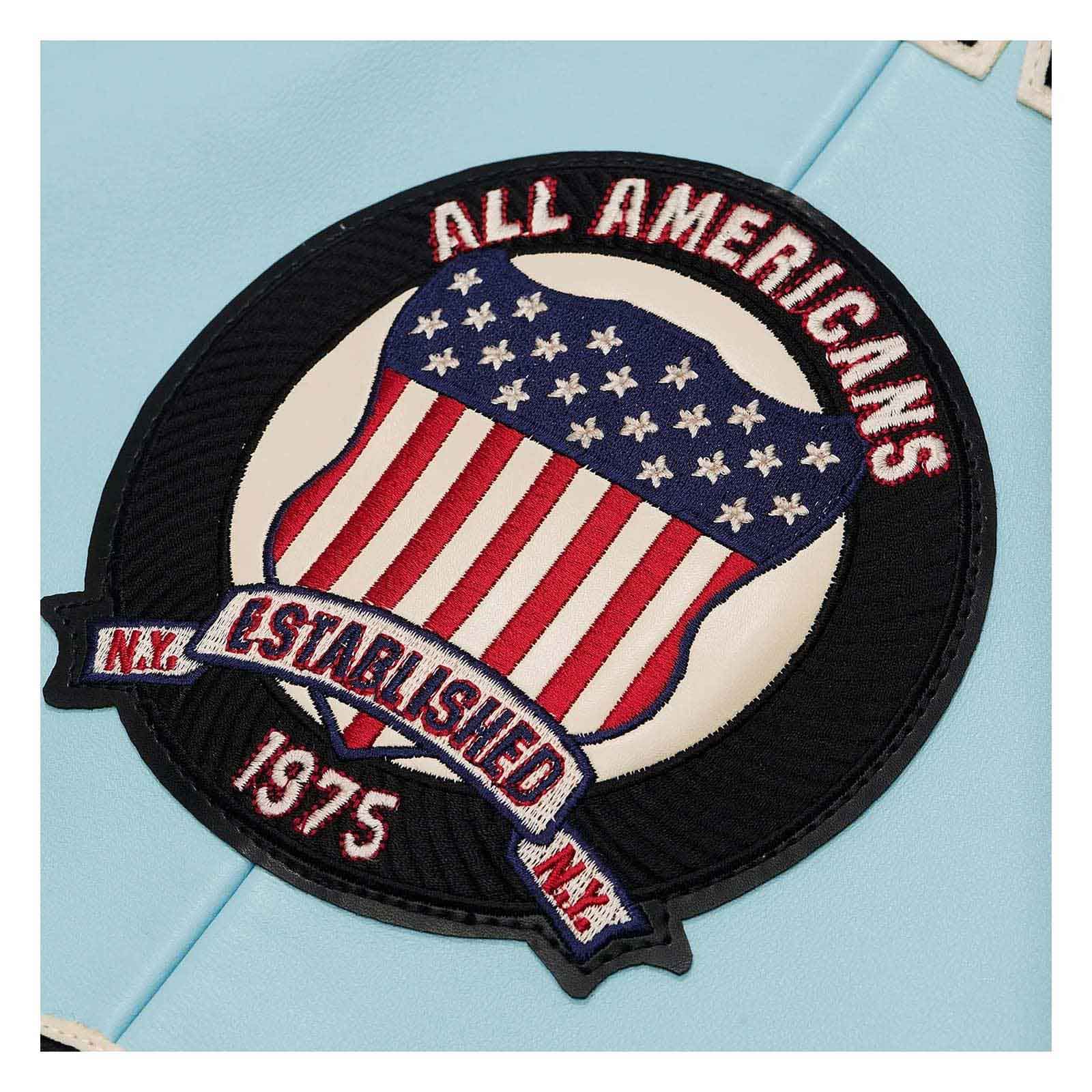 Embroidered patch with American flag design and text on a light blue background