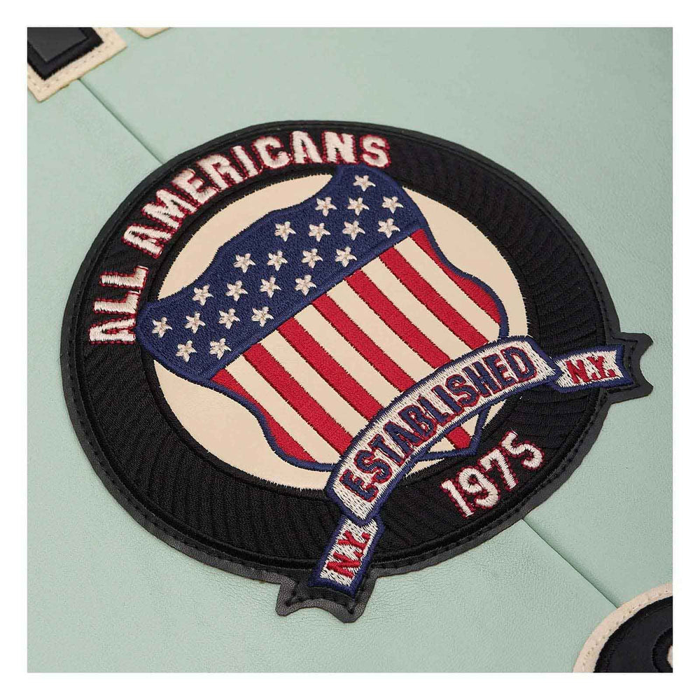 A circular embroidered patch featuring an American flag design with the text 'ALL AMERICANS' and 'ESTABLISHED N.Y.