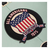 A circular embroidered patch featuring an American flag design with the text 'ALL AMERICANS' and 'ESTABLISHED N.Y.