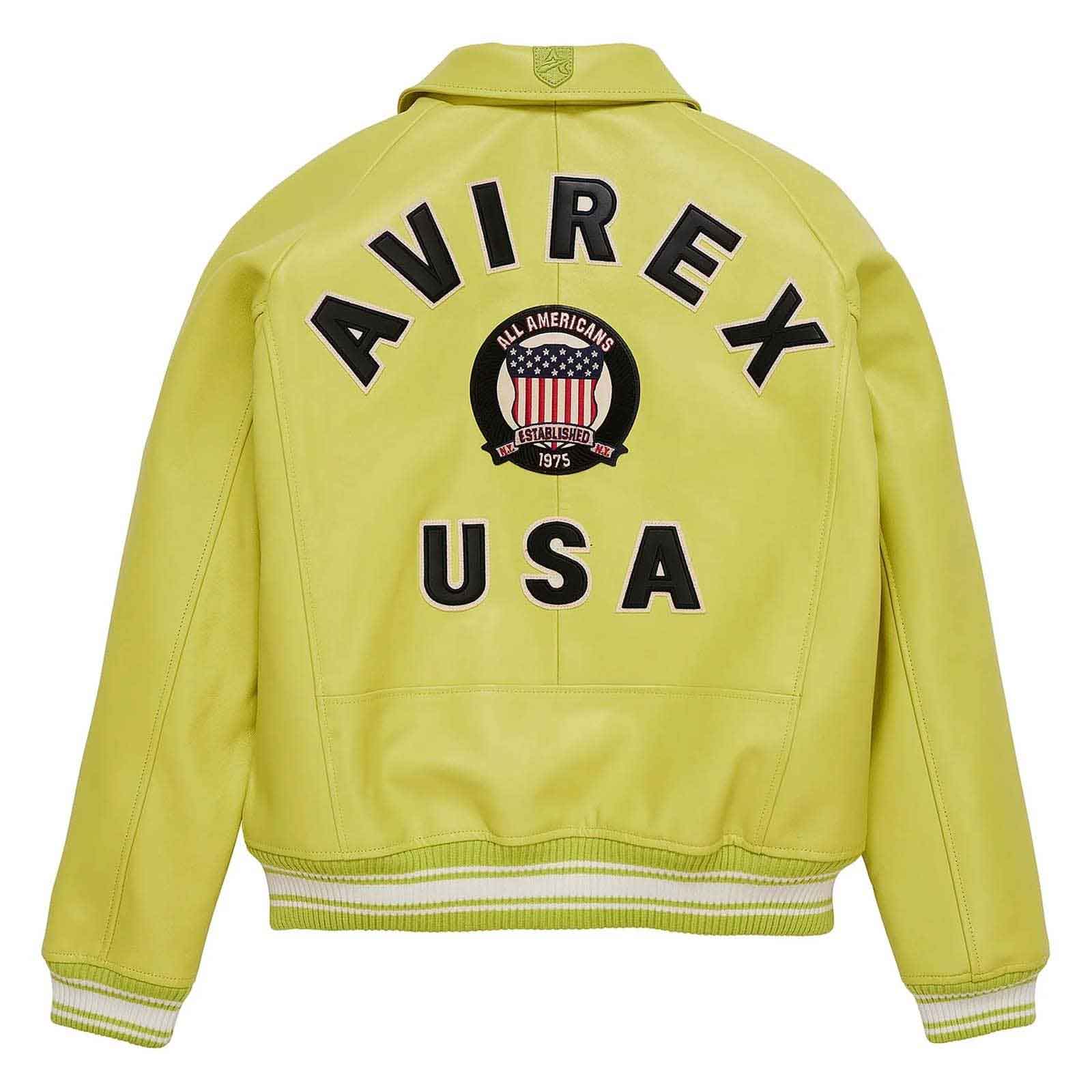 A bright yellow leather jacket shown from the back, featuring 'AVIREX USA' and a circular 'All American Airports' emblem printed in black and red.