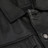 Close-up of metal buttons and chest pocket on black leather jacket