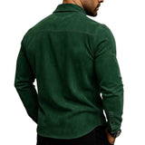 A man wearing a dark forest green long-sleeve shirt, shown from the back against a plain white background.