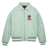A mint green zip-up jacket with a pointed collar, ribbed knit cuffs and hem, and a patriotic chest patch. The brand name 'ANUBE' is visible on the patch.