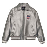 A metallic silver leather bomber jacket with a front zipper, ribbed knit collar, cuffs, and hem. It features a red, white, and blue embroidered shield patch on the left chest with the brand name 'HIMLEY'.