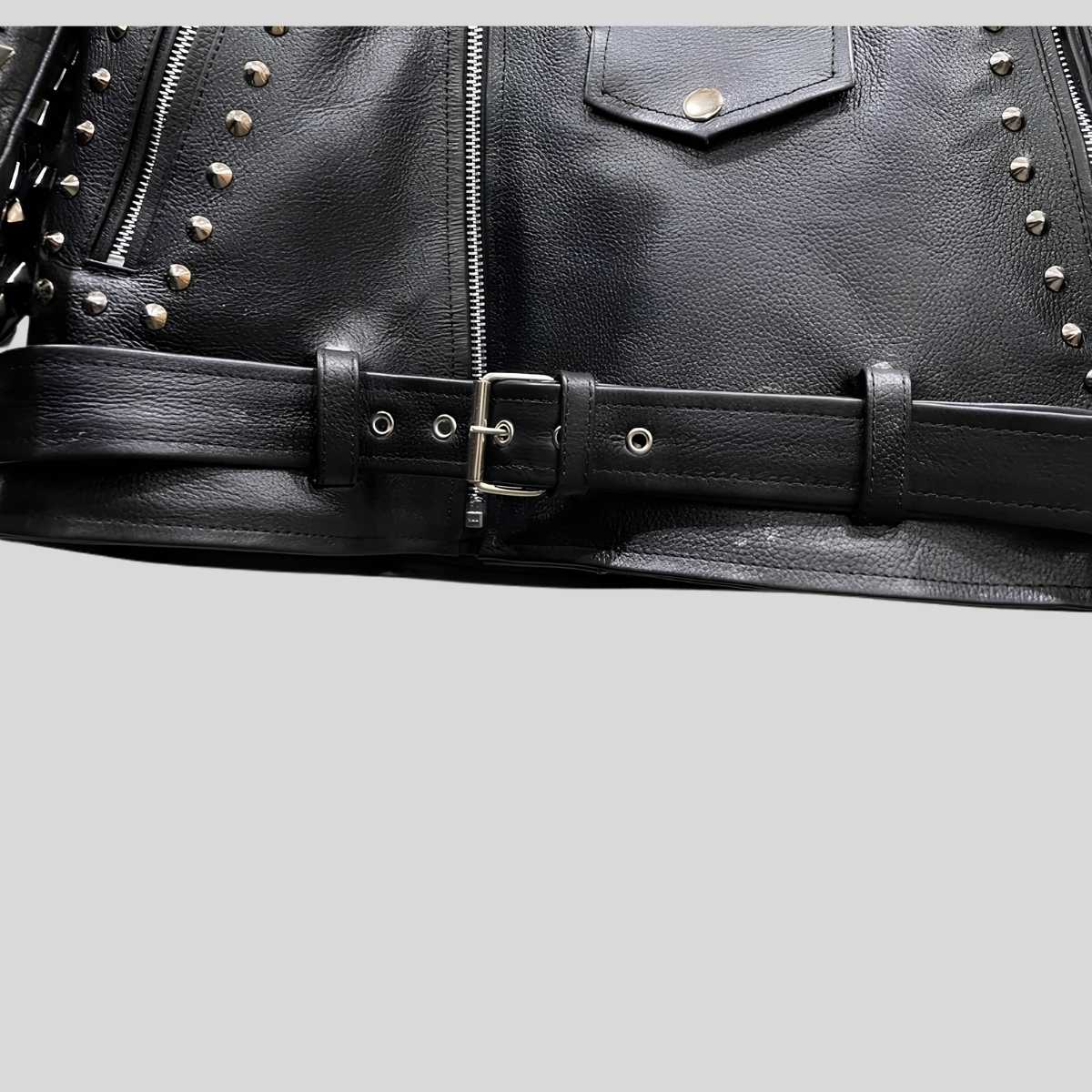 Close-up of hand-punched silver pyramid studs on black cowhide leather