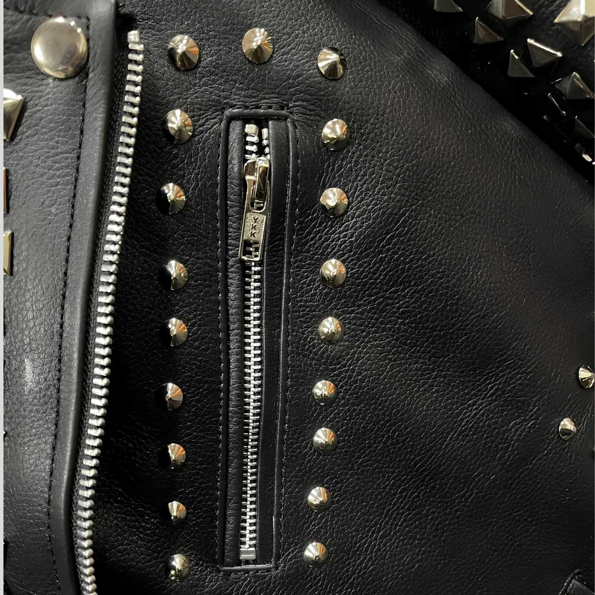 Close-up of pocket silver pyramid studs on black cowhide leather