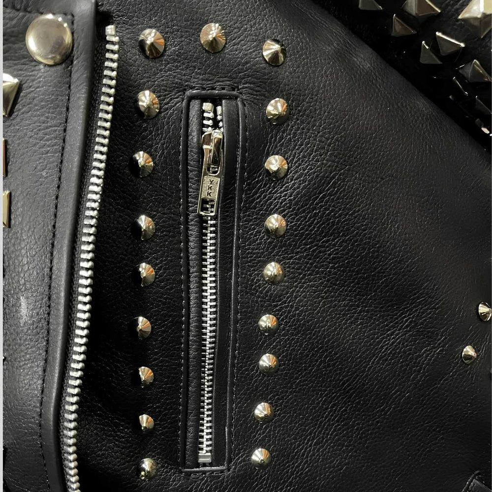 Close-up of pocket silver pyramid studs on black cowhide leather