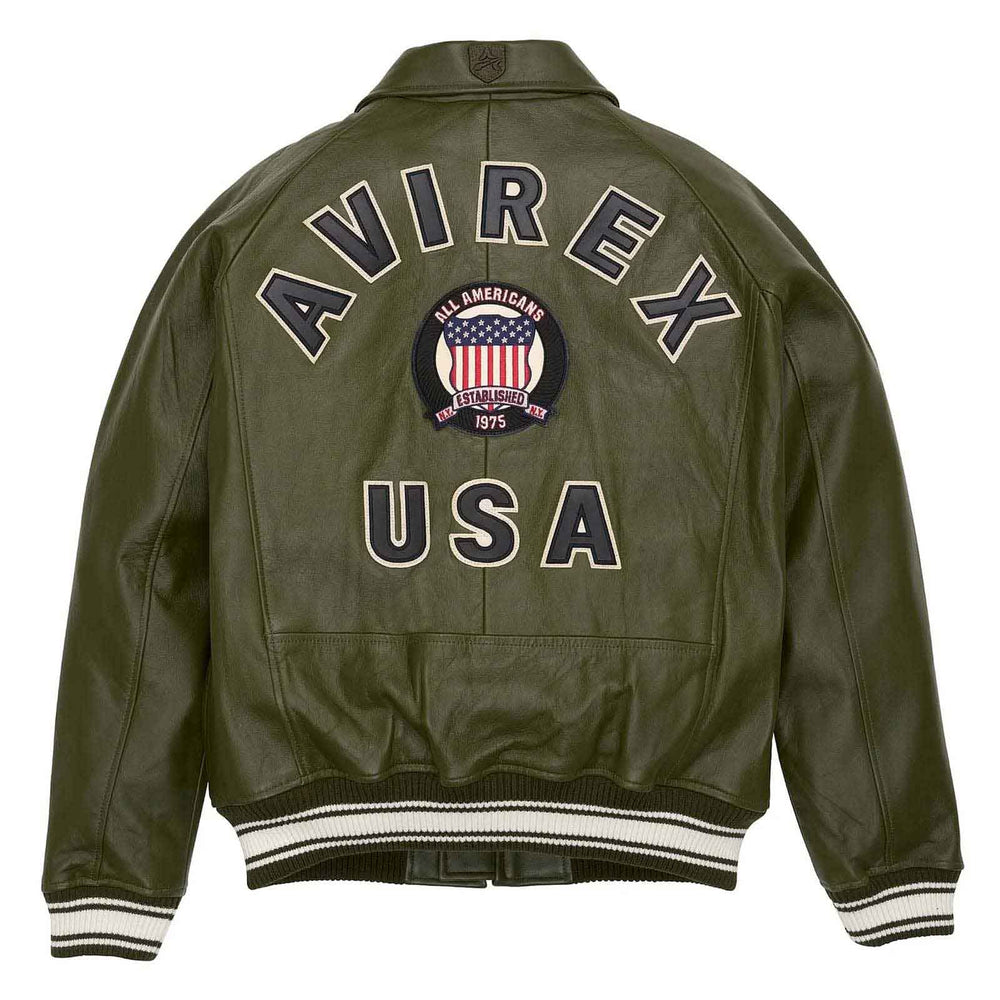 An olive green leather jacket shown from the back, featuring 'AVIREX USA' embroidered in white varsity lettering with a central circular American flag patch.