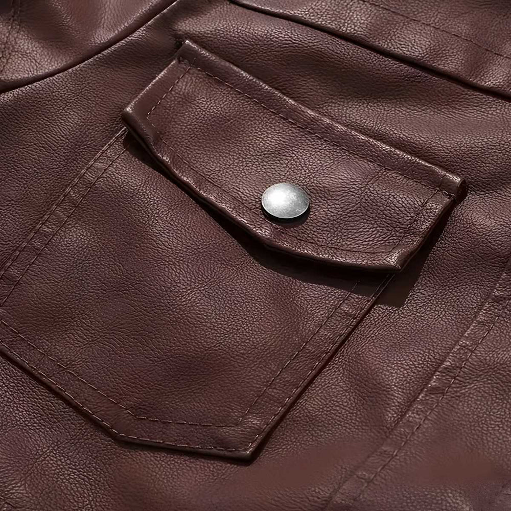 Close-up of zip chest pocket on brown leather bomber jacket