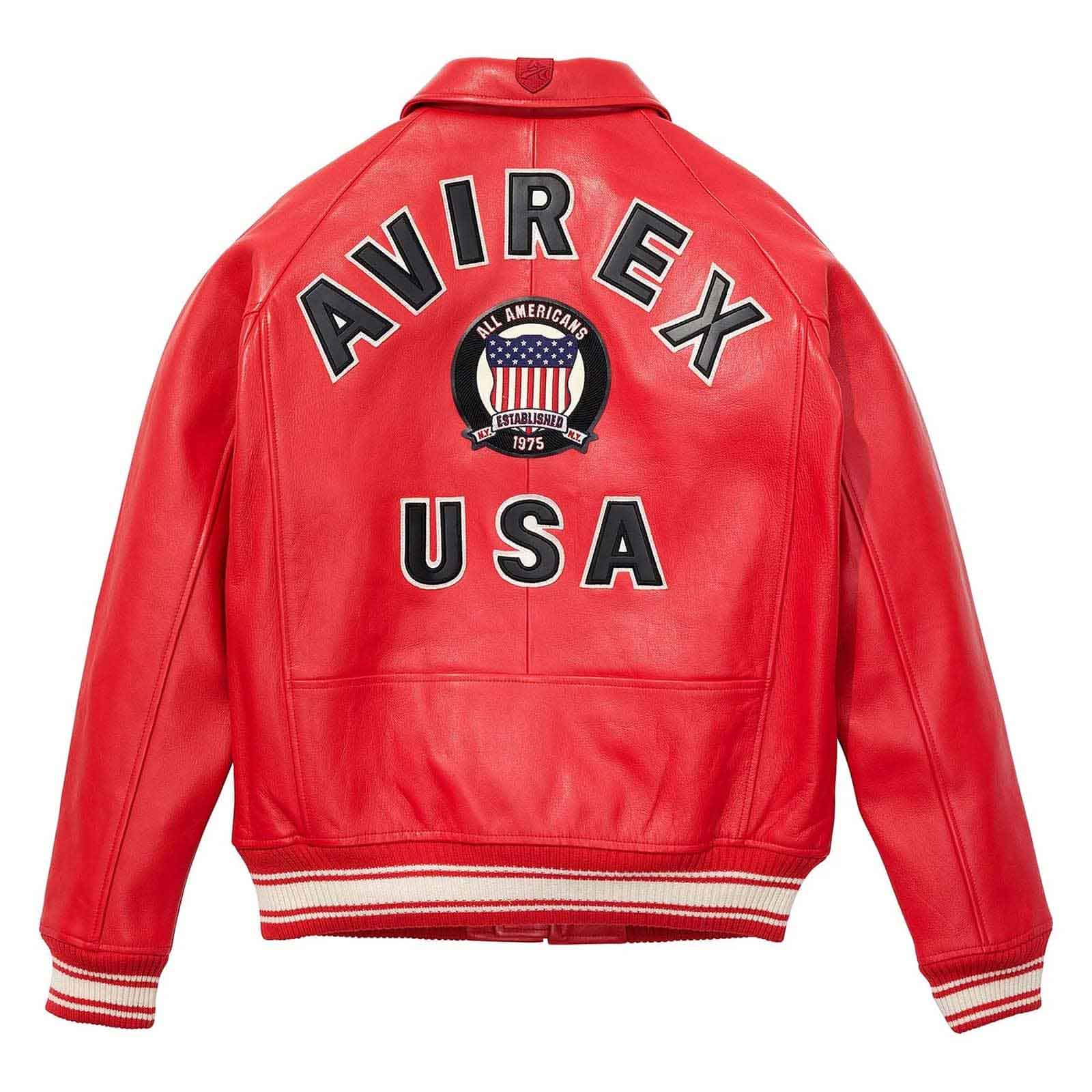 A red leather jacket shown from the back, featuring 'AVIREX USA' and an American flag crest patch printed in black, white, and blue on the back. The jacket has striped ribbed cuffs and hem.