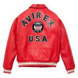 A red leather jacket shown from the back, featuring 'AVIREX USA' and an American flag crest patch printed in black, white, and blue on the back. The jacket has striped ribbed cuffs and hem.