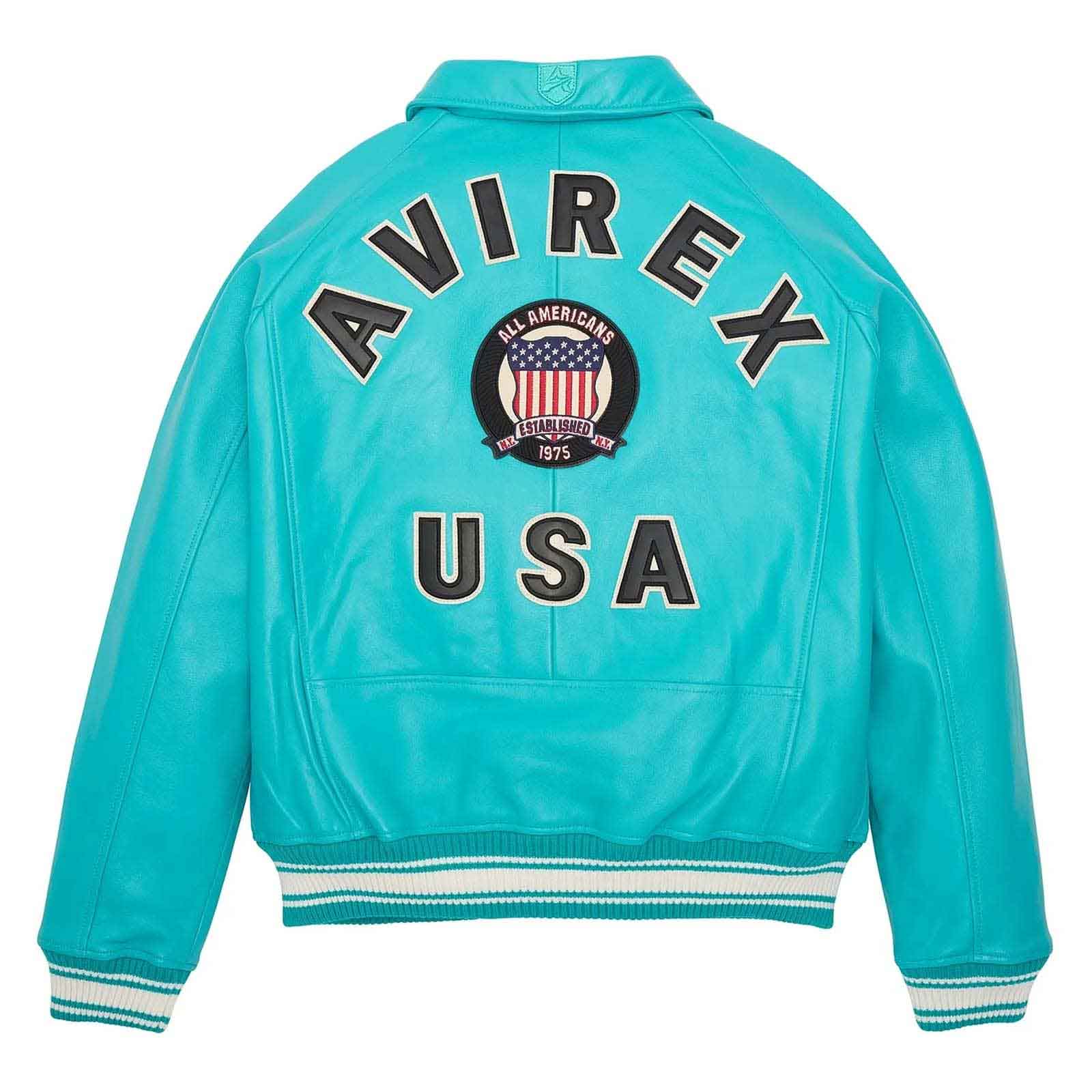 Turquoise leather jacket shown from the back, featuring 'AVIREX USA' in black varsity lettering with a circular American flag crest in the center and striped ribbed cuffs and hem.
