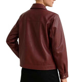 A person shown from the back wearing a dark burgundy leather jacket against a plain white studio background.
