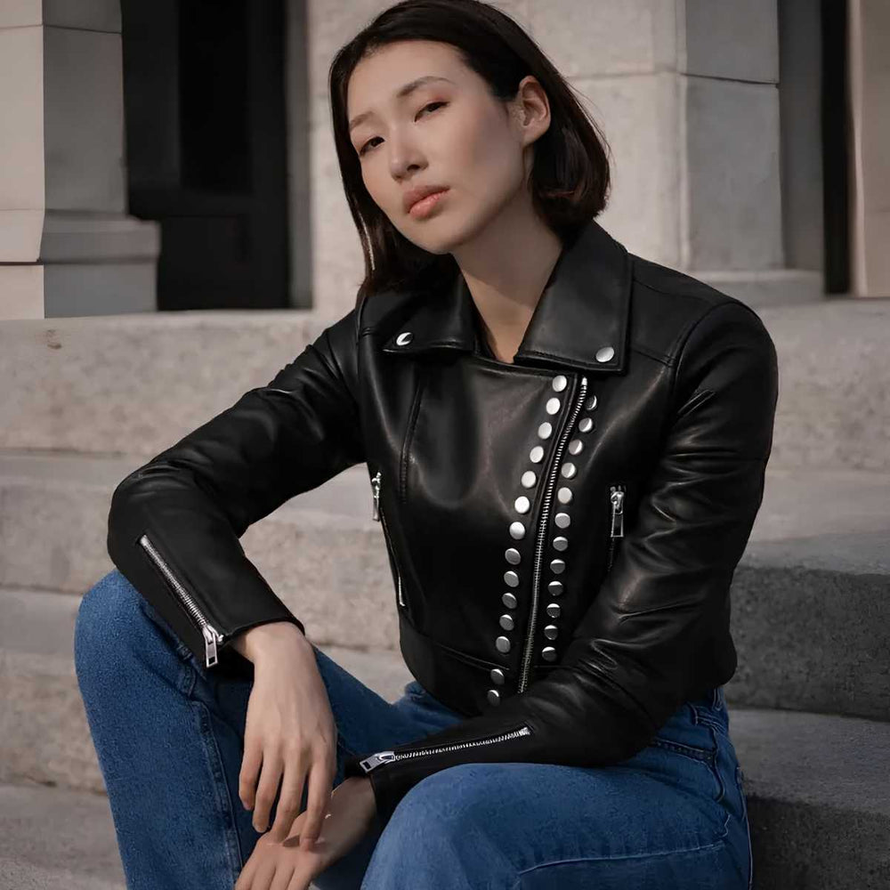 Woman wearing black cropped studded leather jacket with jeans