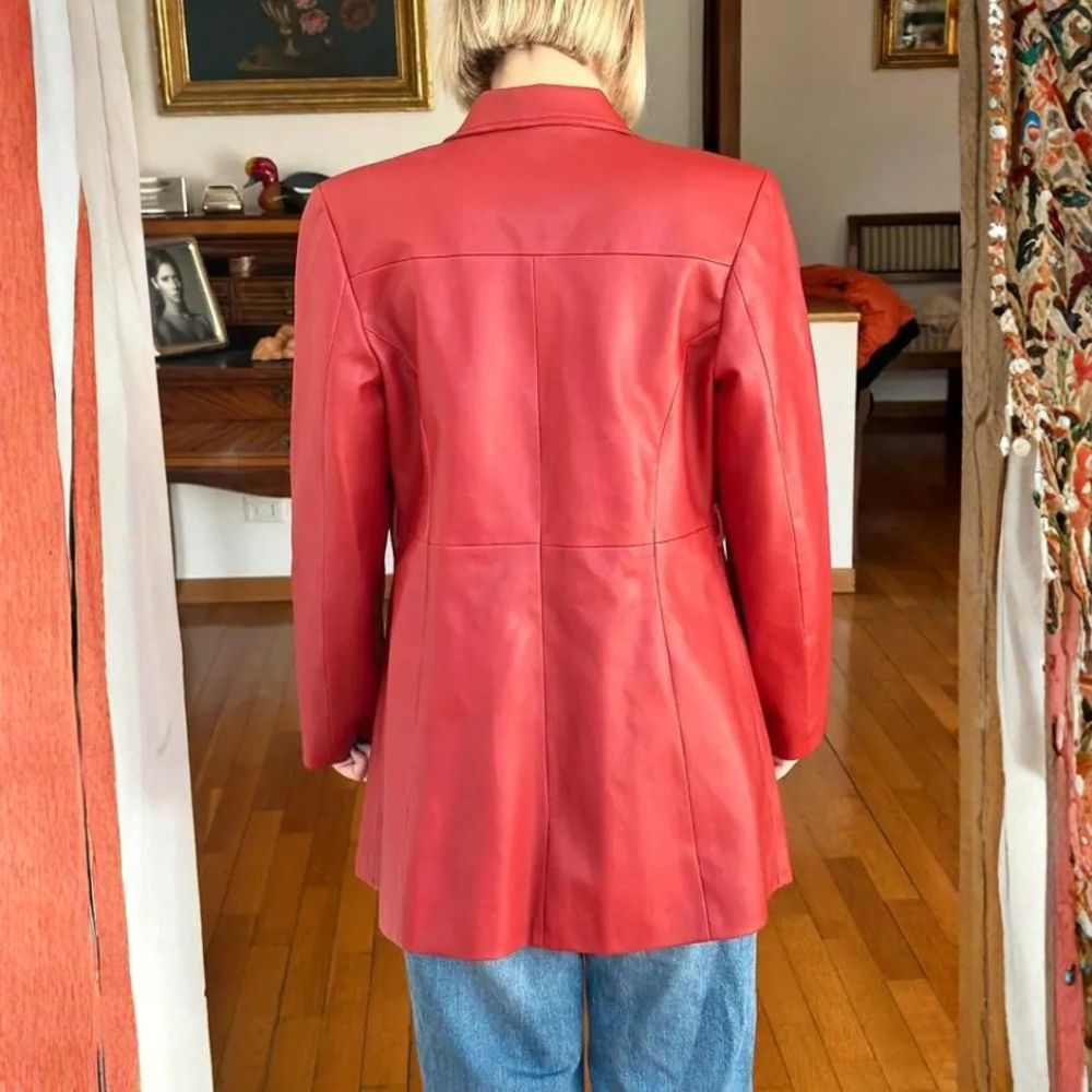 Back view of women's red leather blazer showing mid-length cut