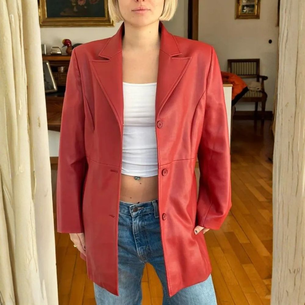 Woman wearing red leather blazer with white top and jeans