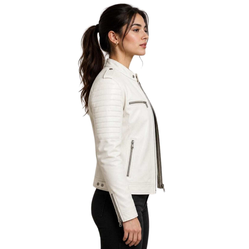 A woman in side profile wearing a white faux leather biker jacket with silver zippers and black pants, set against a plain white background.