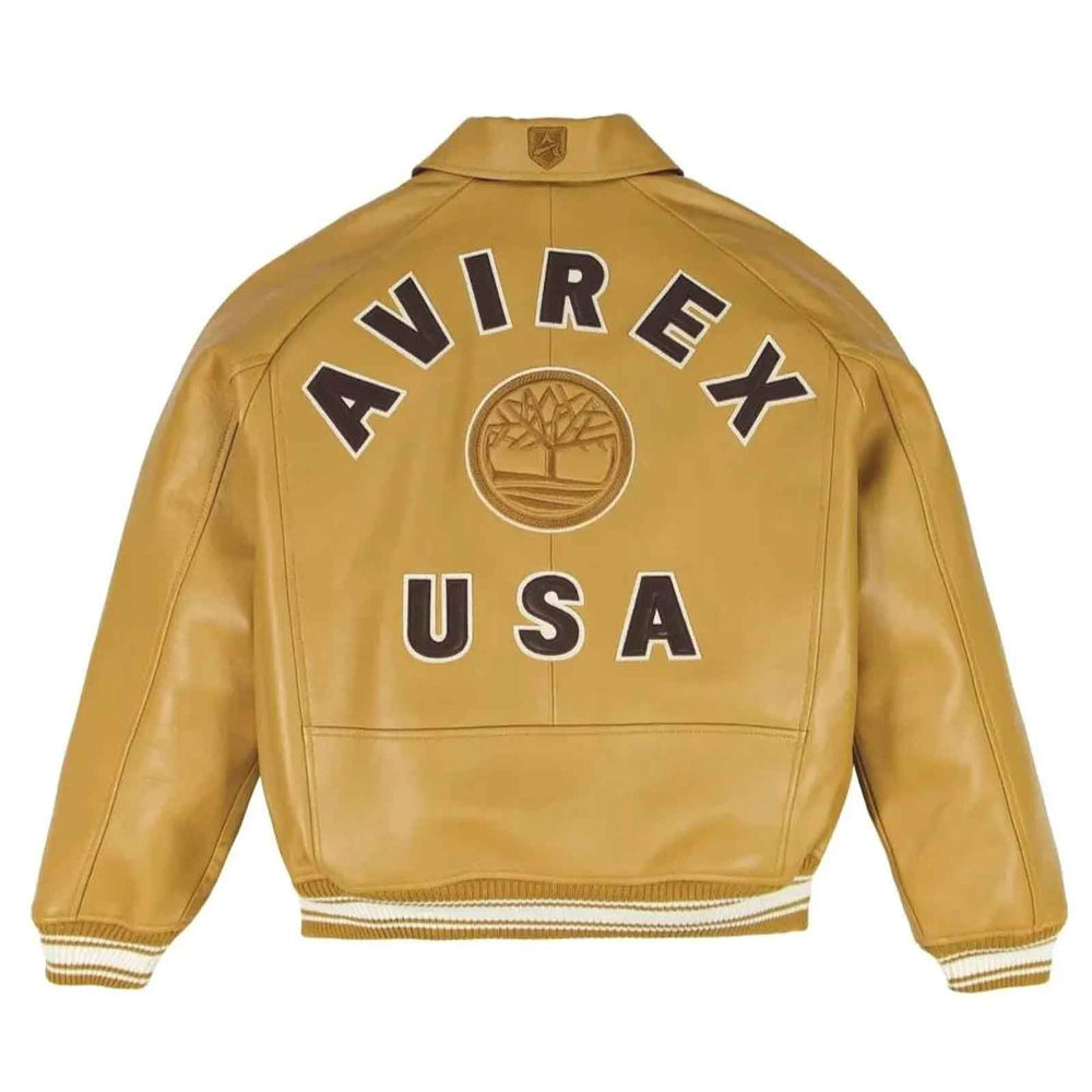 A tan leather jacket shown from the back, featuring 'AVIREX USA' and a tree emblem in dark brown and white embroidery.