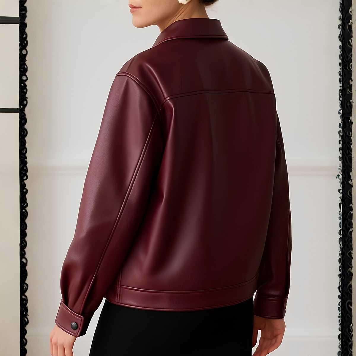 Maroon leather jacket worn by a person on a neutral background