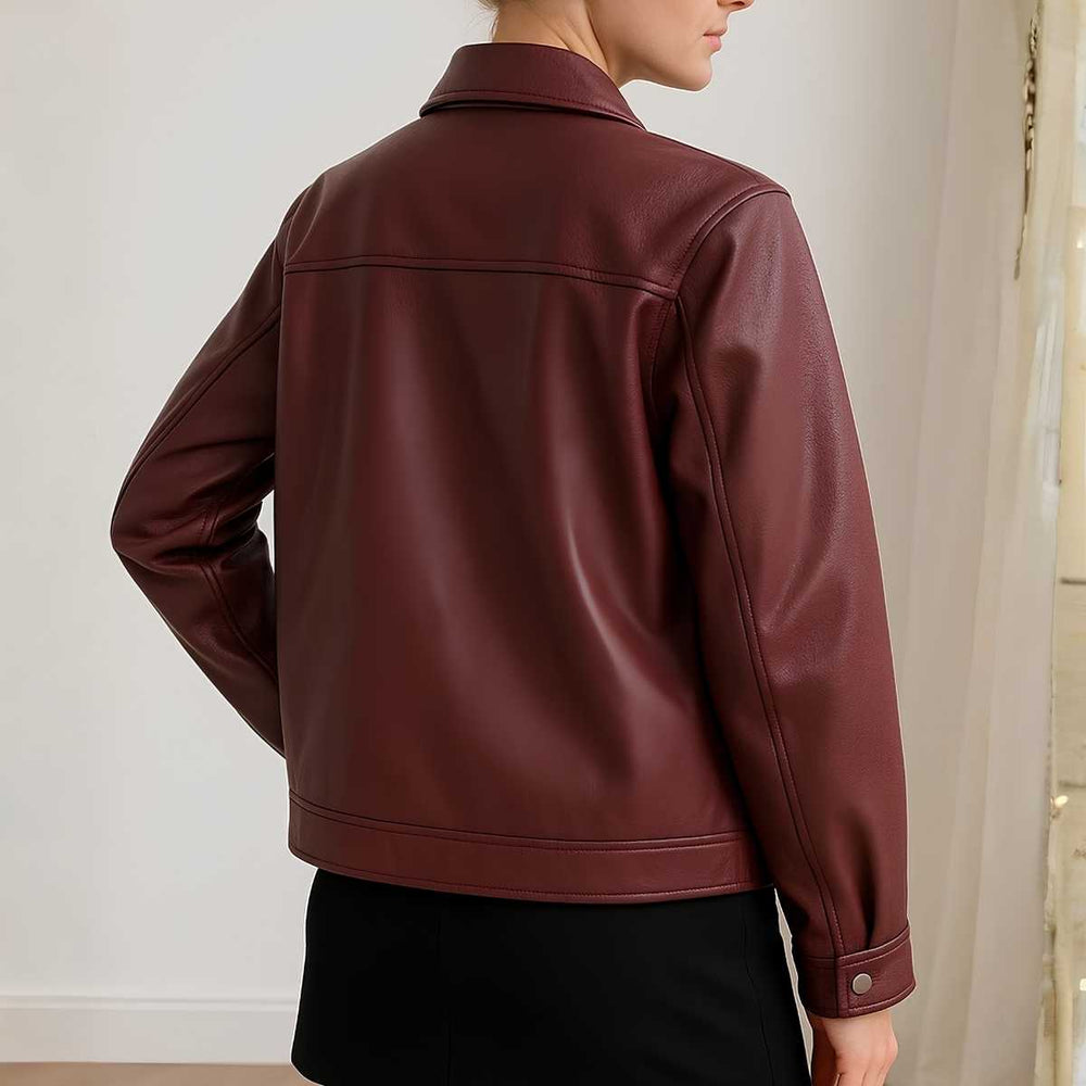 Maroon leather jacket worn by a person against a neutral background